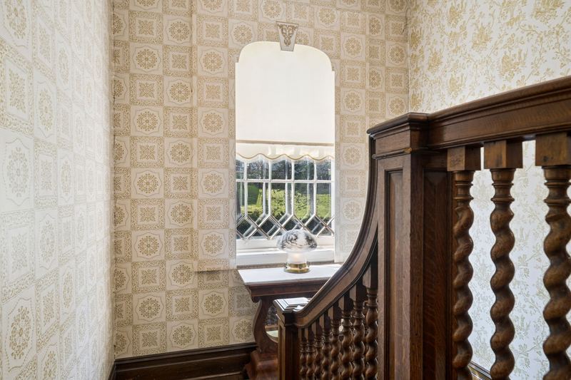 Stair landing with leaded glass window, 700 Meade Street